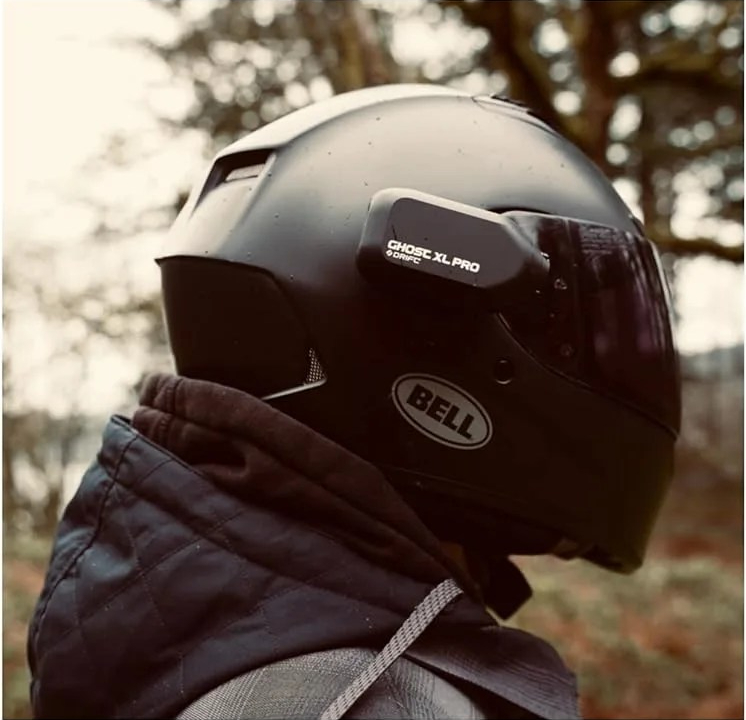 Motorcyclist wearing as Bell Helmet with a Ghost XL Pro Helmet Camera on the side.